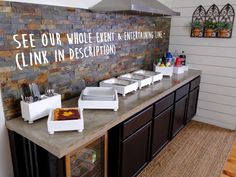 a counter with plates and cups on it in front of a sign that says see our whole event & entertainment line clink in description