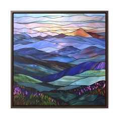 a stained glass window with mountains in the background