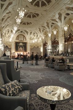 an ornately decorated lobby with chandeliers and couches