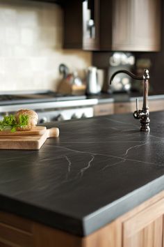 a kitchen counter top with a cutting board on it