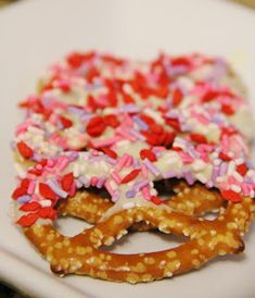 two pretzels with sprinkles are on a plate