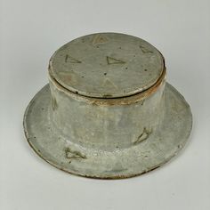 an old white hat sitting on top of a table