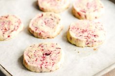 some cookies are on a baking sheet and ready to be baked in the oven or used as an appetizer