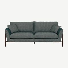 a grey couch with two pillows on it and one arm folded back to the side