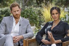 prince harry and his wife are sitting on wooden chairs in front of other people outside