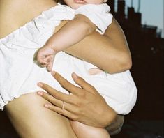 a woman holding a baby in her arms