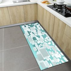 a kitchen with a glass floor mat in the middle and an area rug on the ground