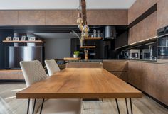 a wooden table sitting in the middle of a kitchen