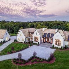 an aerial view of a large home in the country side with lots of grass and trees