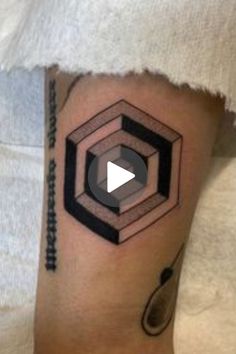 a man's arm with a geometric tattoo design on the left side of his leg