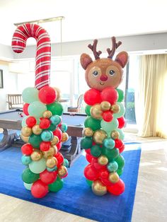 christmas decorations in the shape of reindeers and candy canes on a blue carpet