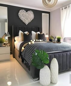 a bedroom with black and white decor on the walls