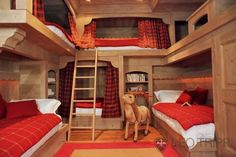 a bunk bed room with two beds and a ladder to the second floor is decorated in red