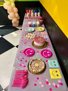 a table topped with lots of cakes and cupcakes