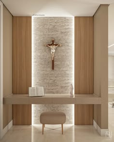 the interior of a church with a crucifix on the wall and a bench