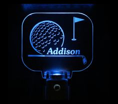 a lighted sign with a golf ball on it and the name madison in blue light