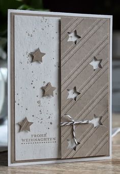 a white card with silver stars on it