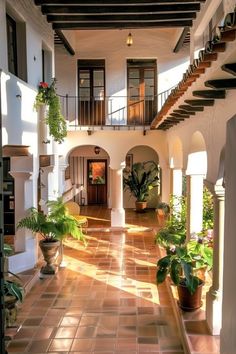 an indoor courtyard with potted plants and stairs