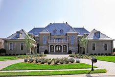 a large house with lots of windows and landscaping