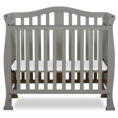 a gray crib with white sheets on the bottom and side rails, in front of a white background