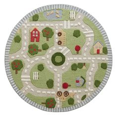 a child's play rug with cars and houses on the road in front of it