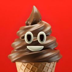 an ice cream cone with chocolate icing and googly eyes