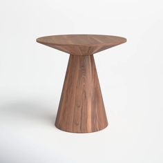 a small wooden table on a white background with no one around it or someone else