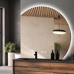 a bathroom with a sink, mirror and potted plant