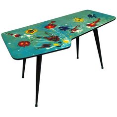 a blue table with flowers painted on it