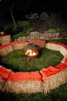 a fire pit in the middle of some grass