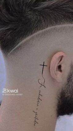 a man with a cross tattoo on his neck and behind the ear is a quote