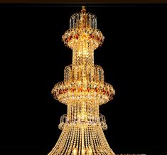 a large chandelier with many lights hanging from it's sides in a dark room