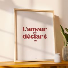 a white framed poster with the words l'amour des declarre on it