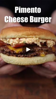 a hand holding a cheeseburger with bacon on it and the words pimentoo cheese burger