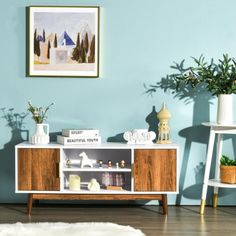 a living room with blue walls and white furniture in the corner is decorated with potted plants