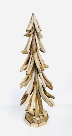 a wooden christmas tree made out of driftwood