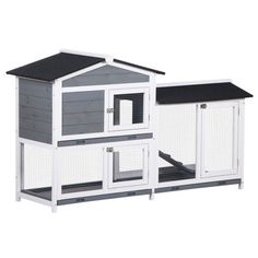 a white and gray chicken coop with black roof