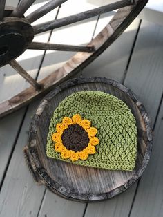 This listing is for a handmade sunflower hat featuring a beautiful textured stitch. Each hat is made with 100% cotton yarn, and is embellished with a crochet yellow and brown sunflower.Pick your hat color from the drop down menu: Cream, Wine, or Sage Green.Size Chart (all measurements are approximate)Newborn: 13”-14”0-3 Months: 15”-16”3-6 Months: 16”-17”6-12 Months: 17”-18”12-24 Months: 18”-19”Toddler (2-4 Years): 19”-20”Child (5-12 Years): 20”-21”Teen/Women: 21”-23”Comes from a smoke free home. Yellow Yarn Hat With Curved Brim, Handmade Yellow Brimmed Crochet Hat, Whimsical Handmade Beanie Hat, Handmade Whimsical Beanie Hats, Cute Crochet Hat With Curved Brim, Whimsical Handmade Beanie, Cute Handmade Yellow Hat, Handmade Yellow Yarn Hat, Cute Handmade Green Crochet Hat