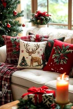 a living room filled with lots of pillows and christmas decorations on top of a couch