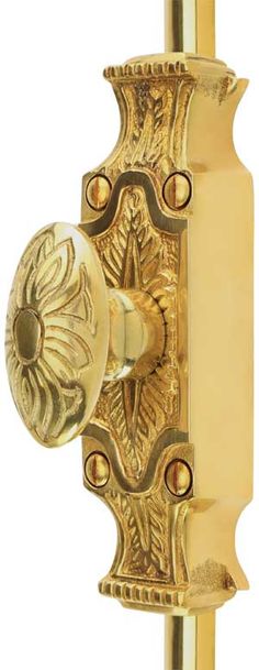 a golden door handle with an ornate design