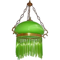 a green chandelier hanging from a chain