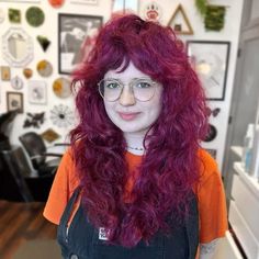 Step into a world where vibrant magenta curls tumble with vivacity, crafting a playful, edgy aura. Tousled bangs part slightly in the center, softening your face's outline, perfect for round faces eager to infuse sass and color into their style. Intrigued? Click for more ideas and follow us on Pinterest! ** Photo Credit: Instagram @pinkdagger Modern Ideas