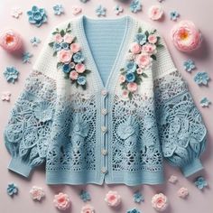 a cardigan with crochet flowers on the front and back, surrounded by pink roses