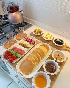 an assortment of food is displayed on a kitchen counter