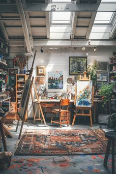 an artist's studio with easels, paintings and other art on the walls