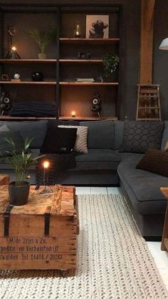 a living room filled with furniture and a wooden box on top of a rug next to a coffee table