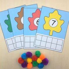 four printable cards with pom poms next to them