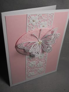 a pink and white greeting card with a butterfly on the front, embellished in pearls