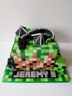 a cake made to look like a minecraft car on a green and brown background