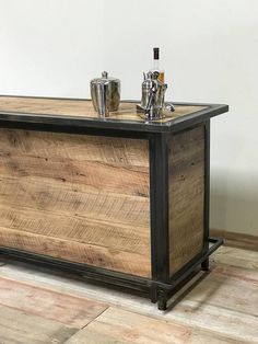 a wooden bar with two glasses on top